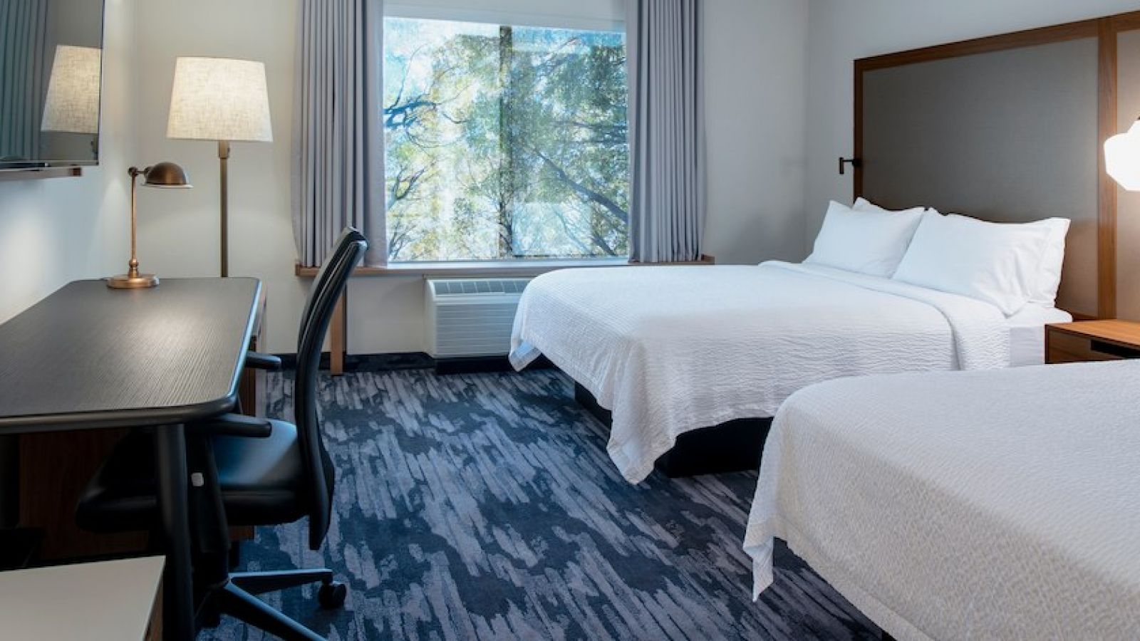Our newly renovated queen/queen guest room features complimentary Wi-Fi, a large flat-screen TV and a functional work space